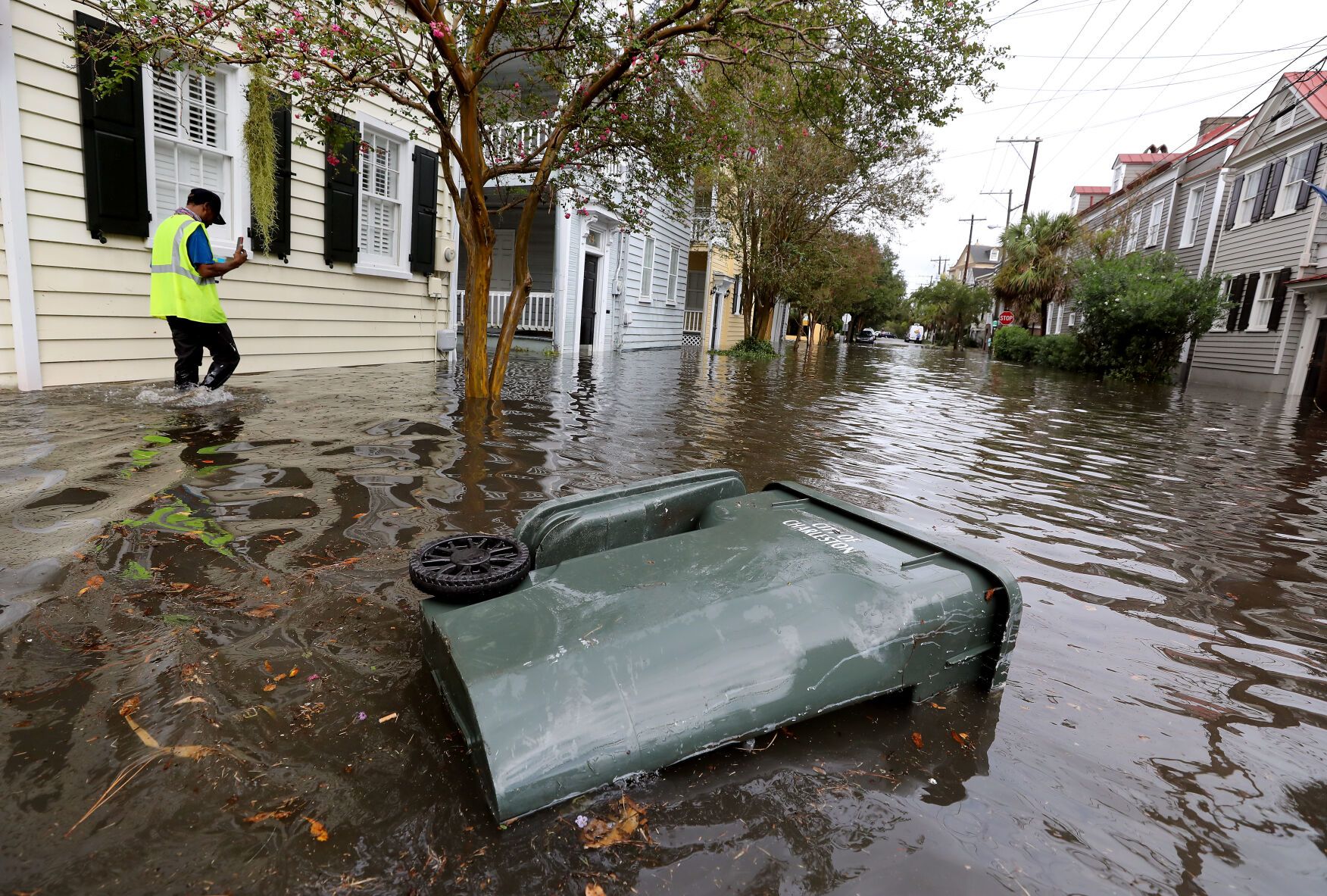 Keith Davis, who works at Ashley Hall, films the flooding from heavy rains on Vanderhorst Street on Friday, Sept. 25, 2020, in Charleston. Image by Grace Beahm Alford / Post and Courier. United States, 2020.