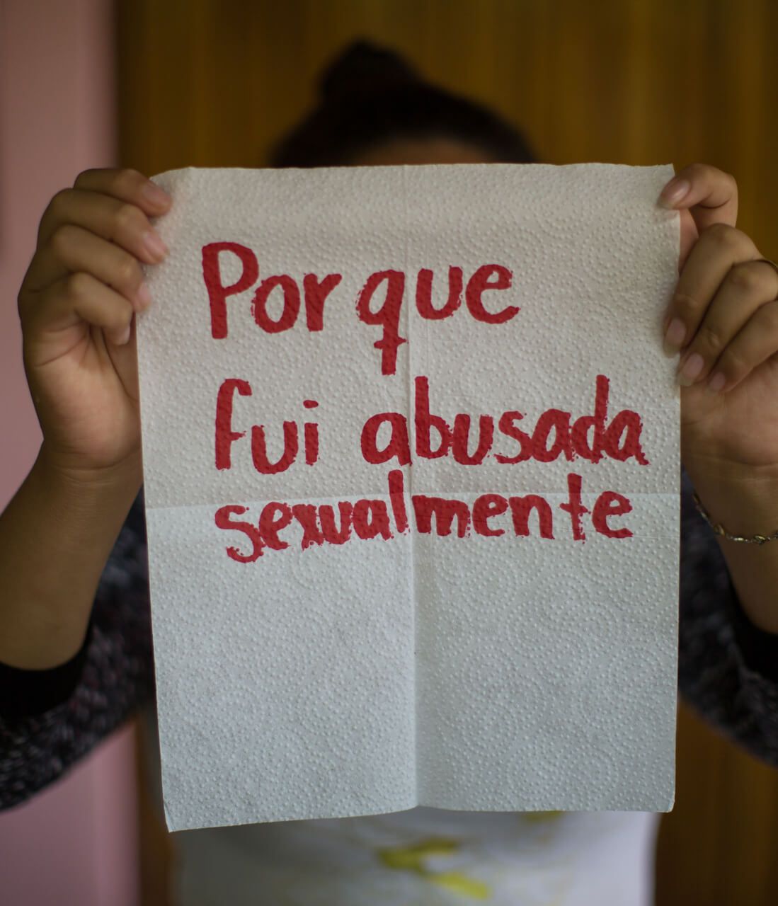 Saraí, 17.

The napkin reads: "because I was sexually abused." She's unable to forget her stepfather, who fondled her when she was only five years old. Saraí started working as a street vendor in buses when she was 7. And the abuse changed. sometimes her grandmother hit her so hard with cables or pieces of wood that her skin showed marks. Even so, now she helps younger children.

Image by Almudena Toral. El Salvador, 2018.