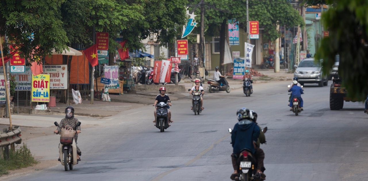 Morning rush hour in the small city of Thai Hoa, Vietnam, about 150 miles south of Hanoi. Image by Mark Hoffman. Vietnam, 2019. 
