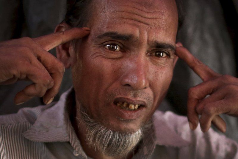 Shafir Rahman, 50, describes how he watched a soldier hammering a four-inch nail into the side of a man’s head with a rifle butt. Image by Wong May-E. Bangladesh, 2017.