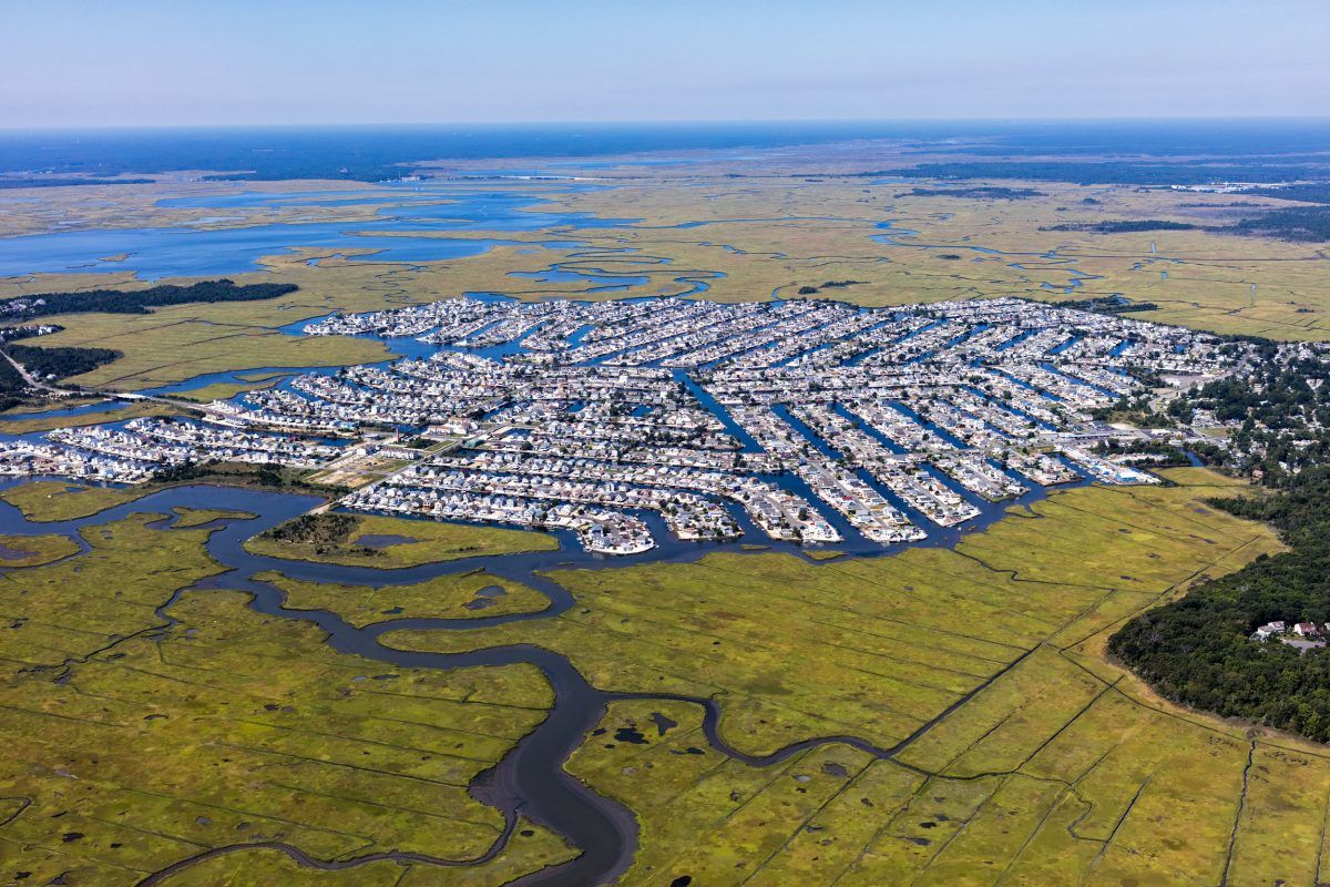 A portion of Egg Harbor Township in New Jersey, carved out of a marsh. Channels cut into the wetland give every homeowner access to the water. A 2015 study predicted that by 2050, 31 percent of Egg Harbor’s land, worth $237.5-million at the time of the report, will be inundated part of every day. Image by Alex MacLean. United States, 2019.