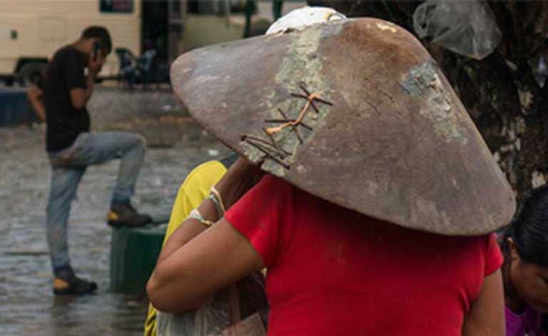 A miner sports a traditional gold pan. While President Maduro has invited transnational companies to the Arco Minero, the region has mostly so far drawn corrupt elements of the military, lawless gangs, and small-scale illegal miners, all competing for claims, sometimes violently. Image by Bram Ebus. Venezuela, 2017.
