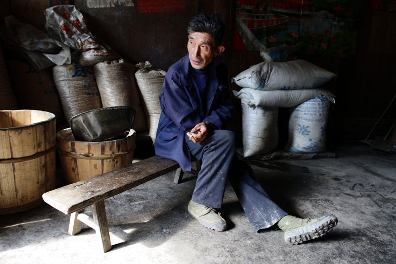 A local man in his home, high in the mountainous forests of Pingwu County.