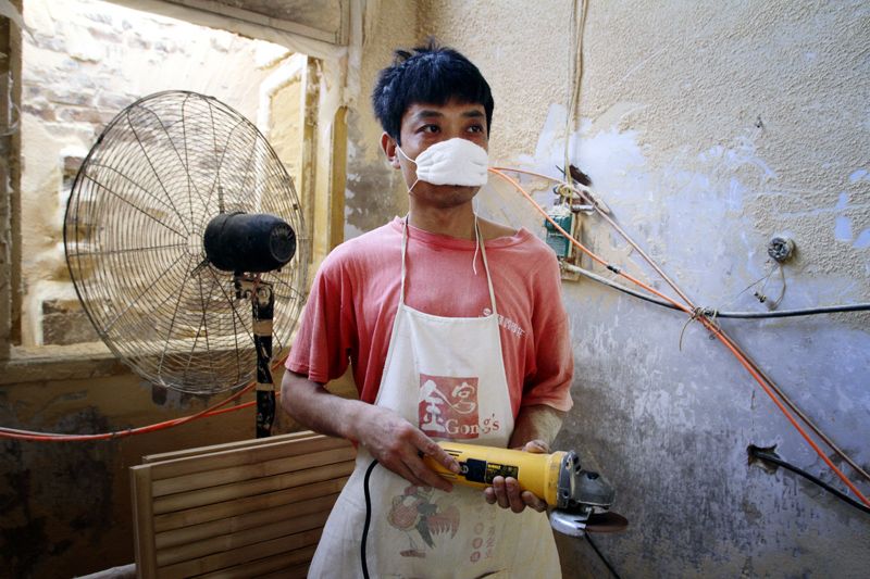 A young man inside a bamboo factory in southern Sichuan.