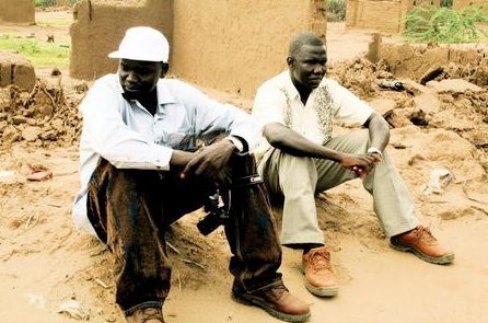 Garang and Gabriel Bol sit on the ruins of their tukul (hut) in Kakuma Refugee Camp. Photo Credit: David Morse, www.david-morse.com