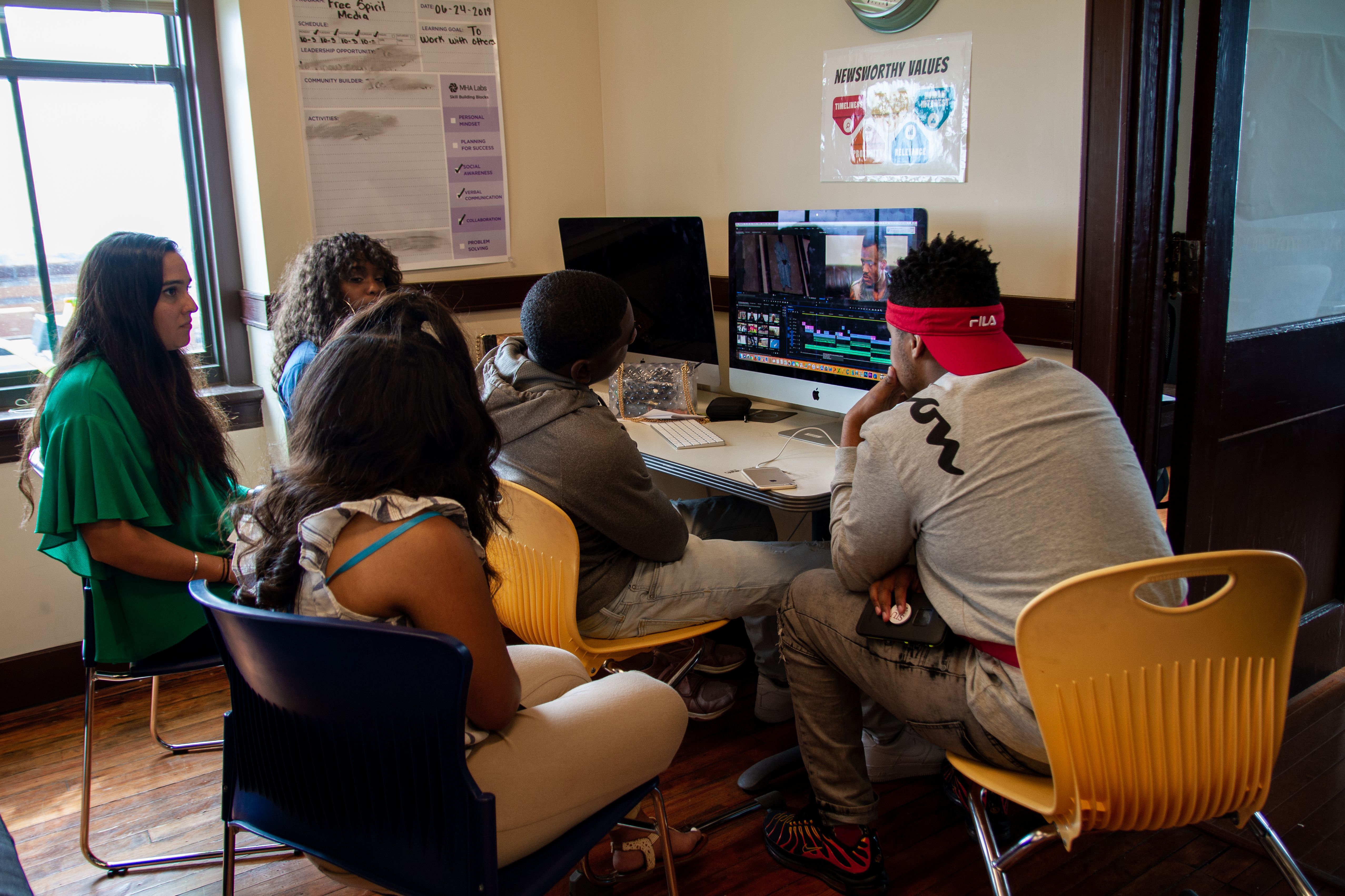 Students work with photojournalist Meghan Dhaliwal to edit Stuck in the System. Image by Claire Seaton. United States, 2019.