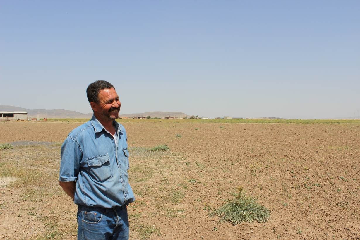 Houssin Ghodbane stands on his farm outside Chemora, Algeria, May 22, 2016. Image by Yasmin Bendaas. Algeria, 2016.