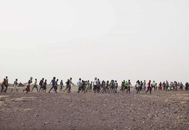 Ethiopian migrants are led by smugglers in Obock, Djibouti, July 14, 2019, prior to crossing the Bab el-Mandeb strait to Yemen. Image by AP Photo / Nariman El-Mofty. Djibouti, 2019.