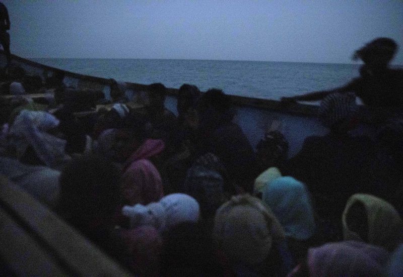 Smugglers ferry Ethiopian migrants in a boat from the uninhabited coast outside the town of Obock, Djibouti, for the trip to Yemen, July 15, 2019. Many of the migrants had never seen the sea before. Image by AP Photo / Nariman El-Mofty. Djibouti, 2019.