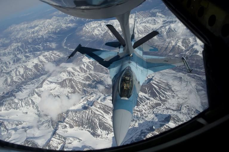 A U.S. Air Force F-16 refuels over Alaska. The fighter is part of the 18th Aggressor Squadron, a unit that plays the role of an attacking enemy—often Russian—during combat training exercises. Image by Louie Palu. United States, 2018.