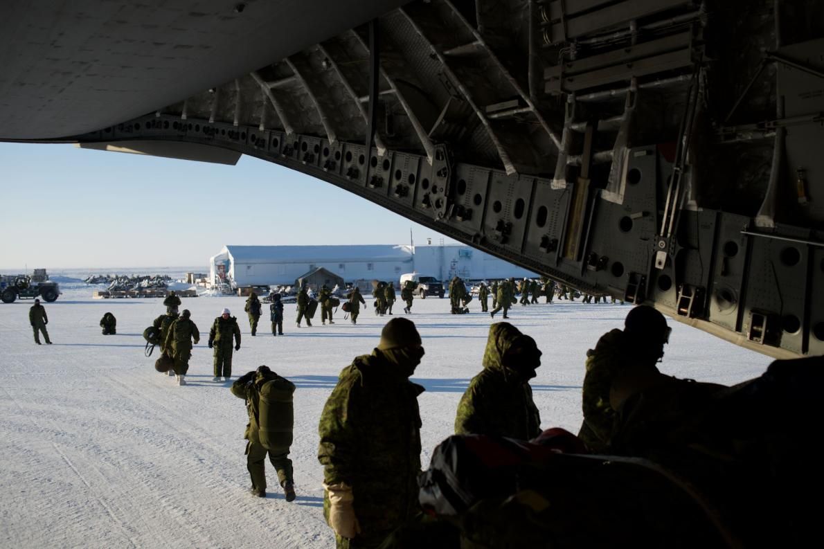 Canadian soldiers disembark from a CC-117 cargo plane during a training mission in Hall Beach, Nunavut. Image by Louie Palu. Canada, 2018.