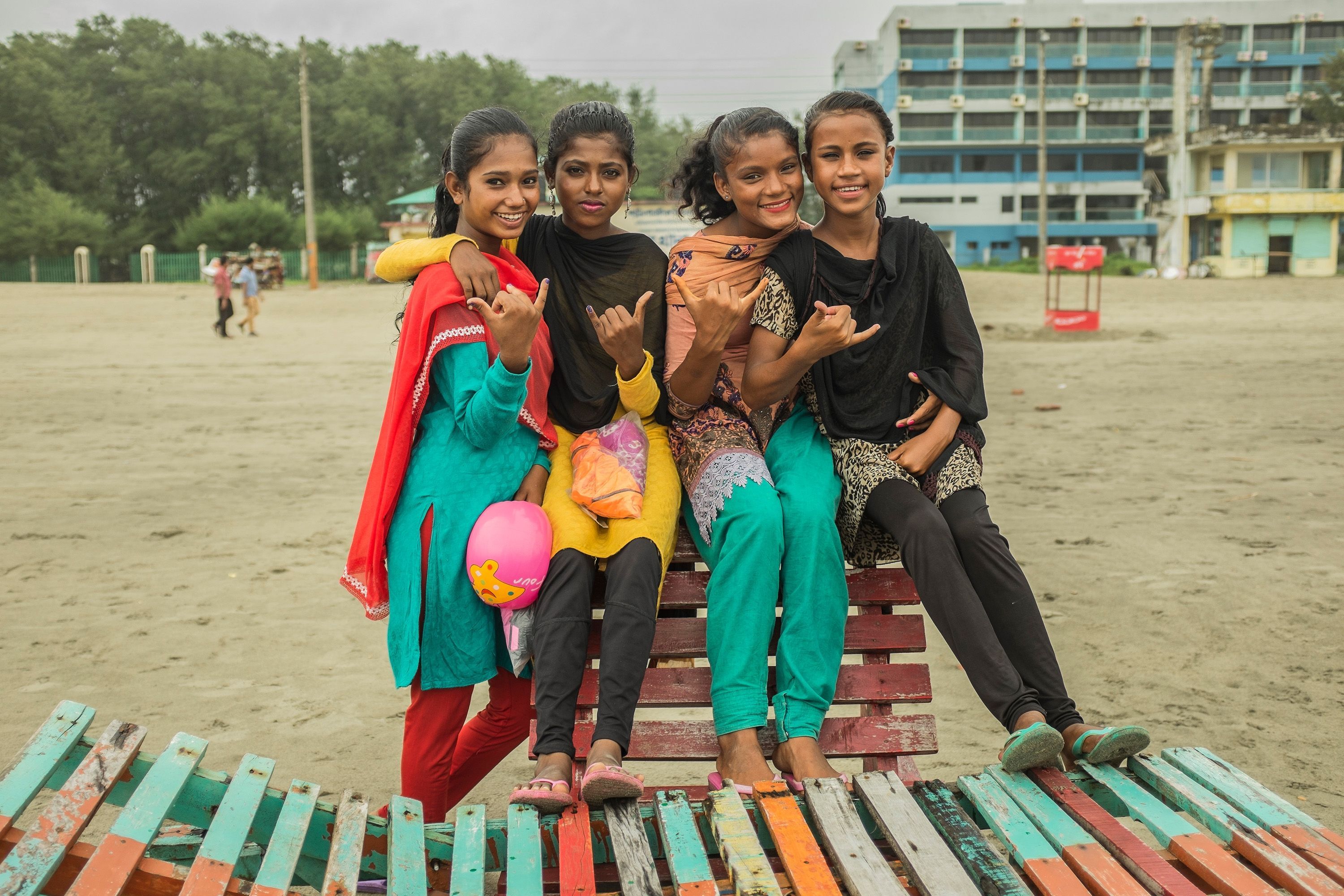 Suma and other girls from the club flash the classic "hang loose" sign. Image by Giulio Paletta. Bangladesh, 2017.