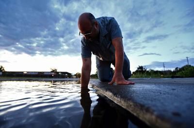 Norman Levine, director of the College of Charleston’s Lowcountry Hazards Center, studies tidal flooding on Charleston’s East Side. Image by Tony Bartelme/The Post and Courier Staff. United States, undated.