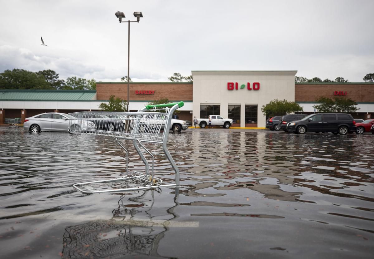 An abandoned grocery cart sits in floodwaters in a grocery store parking lot on Johns Island on May 20, 2020. Image by Lauren Petracca/The Post and Courier Staff. United States, 2020.