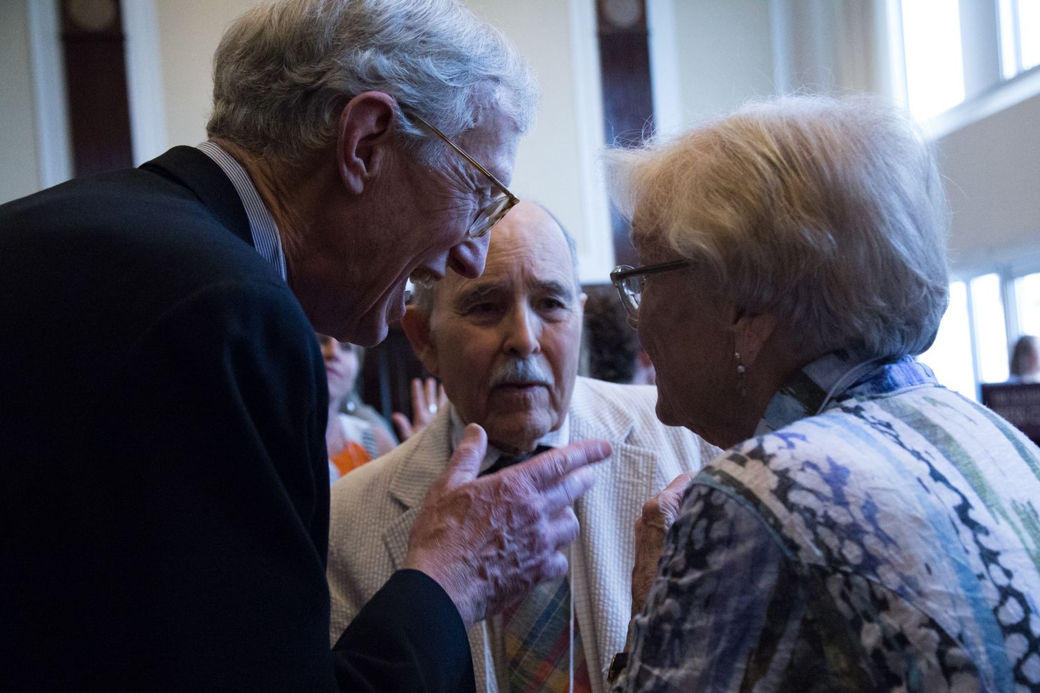 Pulitzer Center board member Richard Moore speaks with guests Lincoln Day and Alice Day. Image by Lorraine Ustaris. Washington, D.C., 2018.