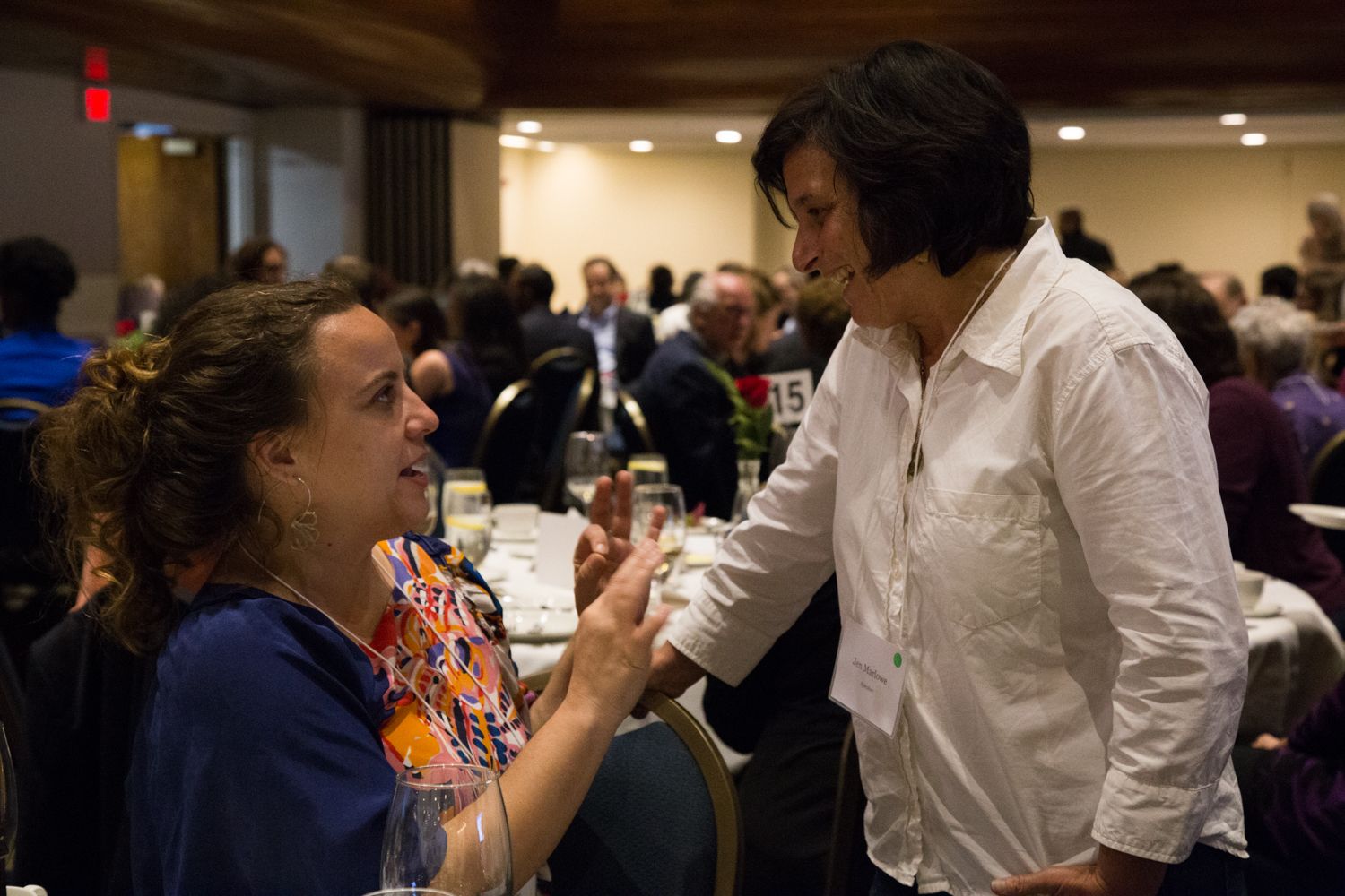 Jina Moore, East Africa Bureau Chief for The New York Times, and filmmaker Jen Marlowe converse during a break between dinner speakers. Image by Lorraine Ustaris. Washington, D.C., 2018. 