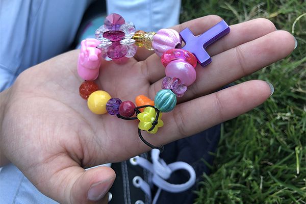 “Each bead means something,” Adrianna says of the bracelet she made me with her mom. “This one,” she says, pointing to the shiniest pink bead, “is supposed to be how much love she has for us because it is so bright." Image by Jaime Joyce for TIME Edge. California, 2018.