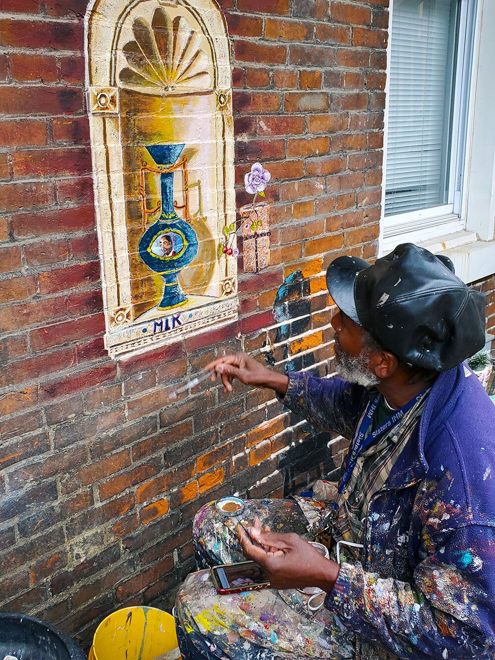 Jamaica Ray paints elaborate, tropical and cultural images on the exterior of a historic two-story building in the Old North neighborhood. Image by Sylvester Brown Jr. United States, 2020.