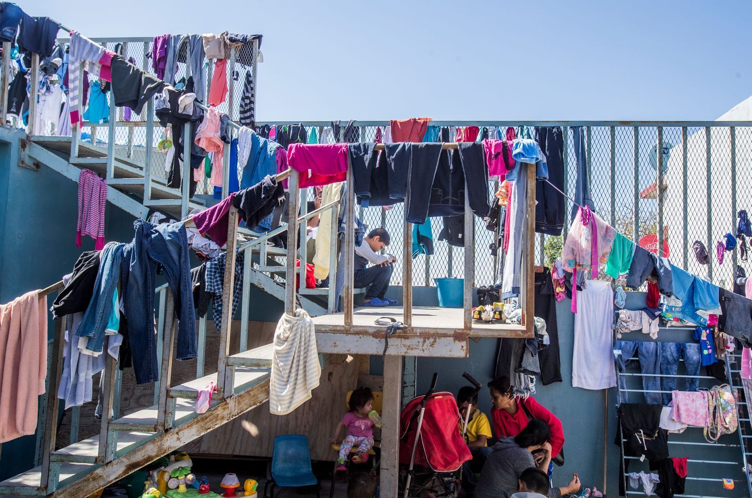 In Tijuana, the poorest asylum seekers bide their time in shelters, where they do their laundry and eat communal meals. Image by Omar Ornelas/The Desert Sun. Mexico, 2019.