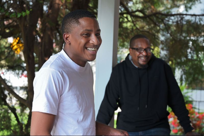 Cecil "C.J." Burton III, left, said his father "never stopped trying" to provide for him and his siblings, despite the child support debt that piled up over decades. Now 54, Cecil Burton is still paying the debt, much of which is owed the government for welfare C.J. and his siblings received when growing up. Image by Karl Merton Ferron / Baltimore Sun. United States, 2019. 