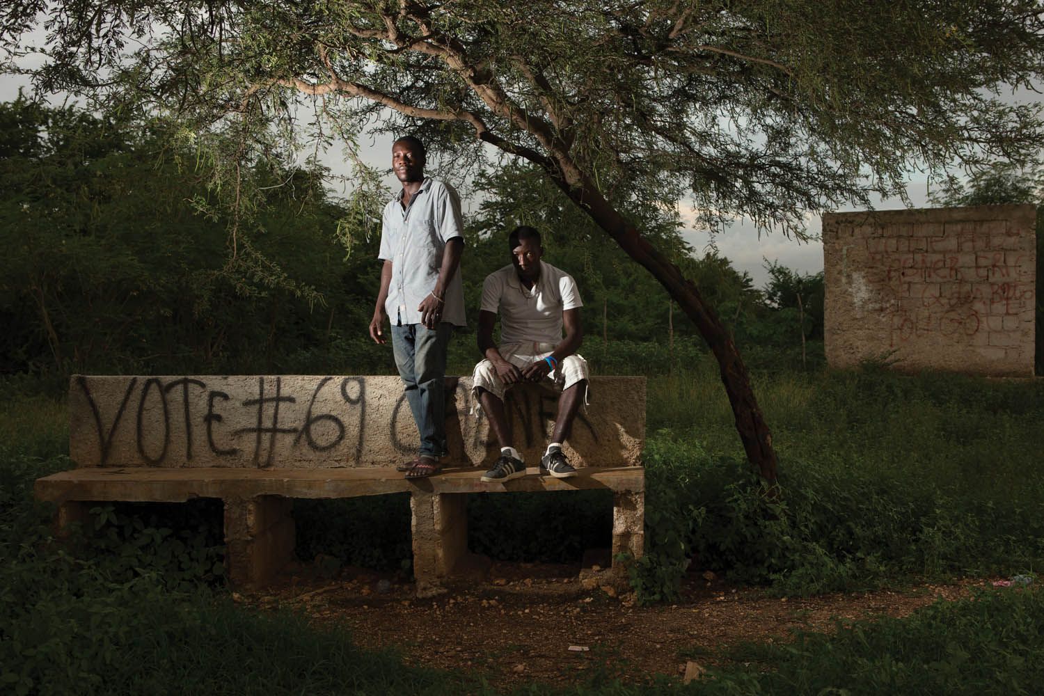Evenson Louis (left) and Accene Appolon in a park they helped to preserve in the neighborhood of Canaan 1. Evenson actively protects greenspaces for the community. Image by Allison Shelley. Haiti, 2017.
