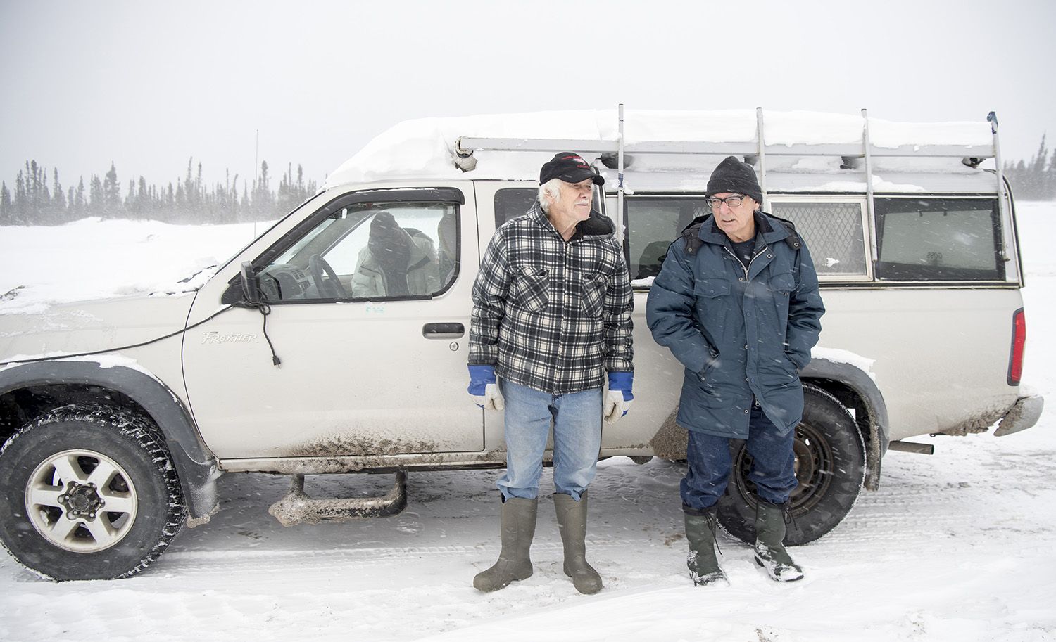 Jim Learning, left, and Davis stand by Learning’s truck at the gate to Muskrat Falls Generating Facility on the North Spur near Happy Valley-Goose Bay, Newfoundland and Labrador, on Nov. 16, 2019. Image by Michael G. Seamans. Canada, 2019.