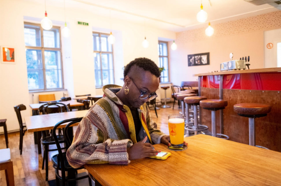 After finishing work at 'Queer Base' in Vienna, Faris has a beer in the queer friendly
space Villa Vida in central Vienna, Austria's capital. Image by Bradley Secker. Austria, 2020.