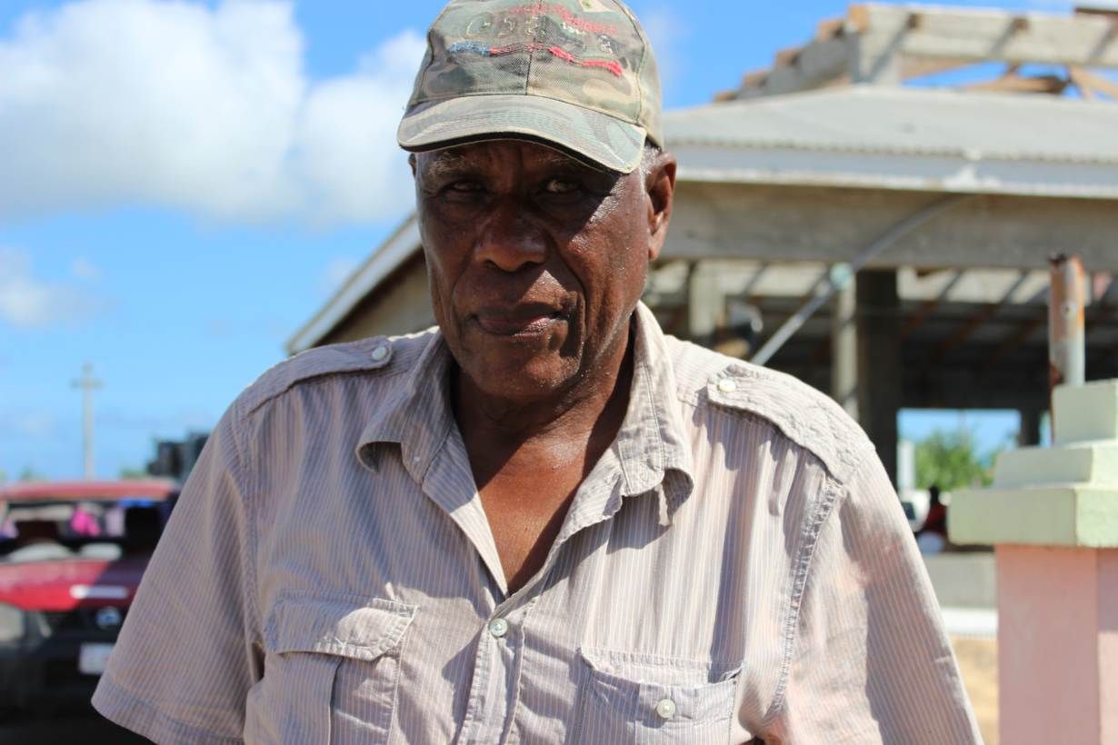 "Barbuda land is not for sale," insists Clifton Walbrook as he stands outside his house wrecked by Hurricane Irma on November 17, 2017. An estimated 90 percent of properties were damaged in Barbuda when the Caribbean island was hit by Irma on Sept, 6, 2017. Image by Gregory Scruggs. Barbuda, 2017.