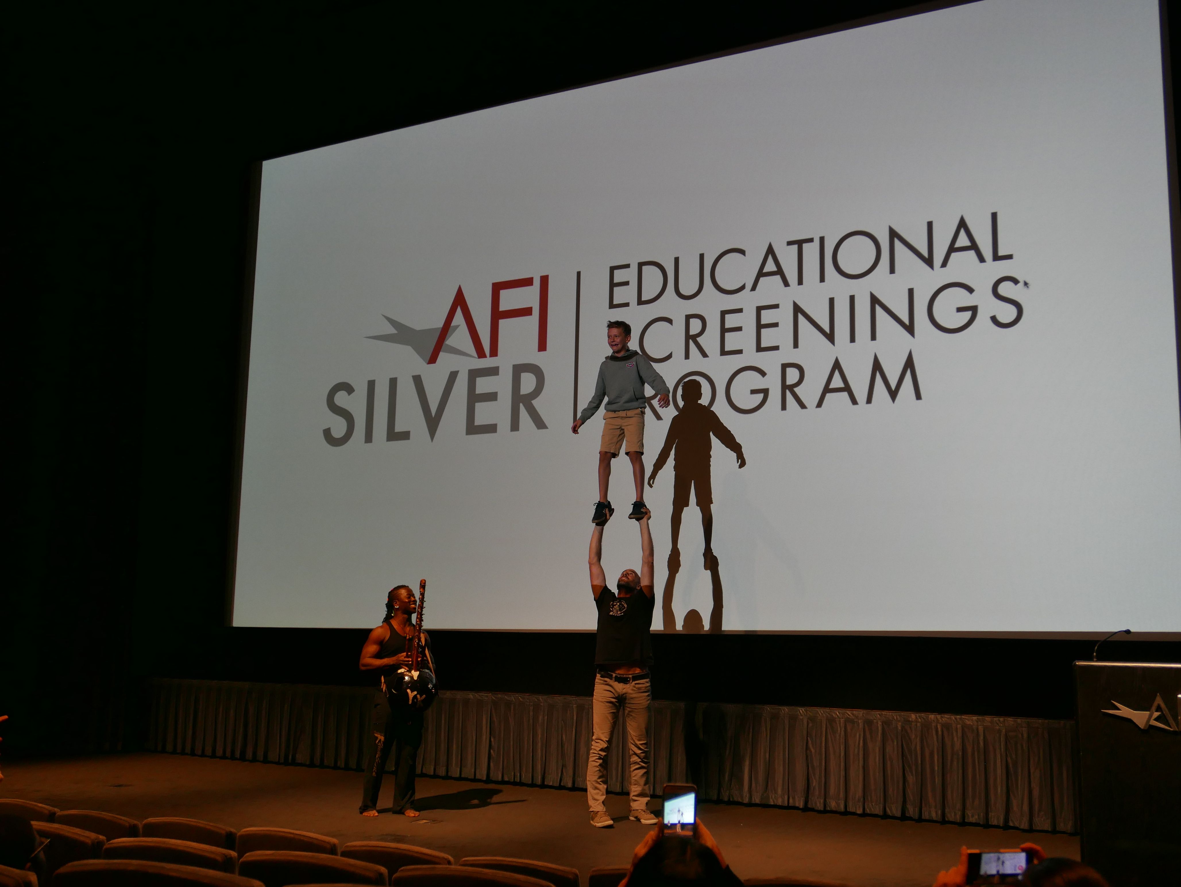 Guillaume Saladin and Yamoussa Bangoura talk and perform for DC students at the American Film Institute Silver Theater after a screening of Circus Without Borders. Image by Meerabelle Jesuthasan. USA, 2019.