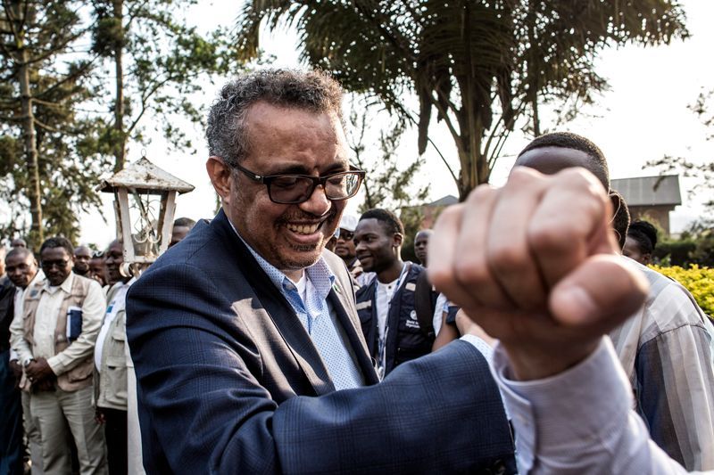 Tedros greets colleagues in Butembo with what has become the unofficial salutation for Ebola responders. Image by John Wessels. Democratic Republic of Congo, 2019.
