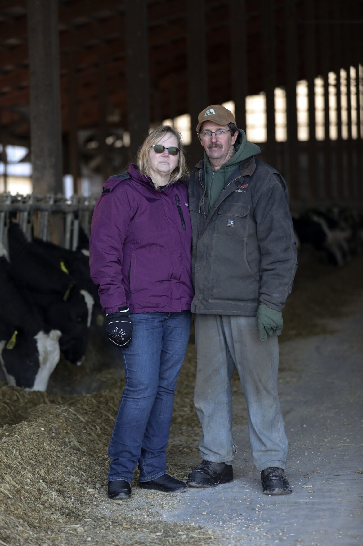 Amy and David Fischer are seen on their 350-cow dairy farm, Darian Acres, in Rio, Wis., on Dec. 18, 2020. Their son, Brian, died by suicide at the age of 33 on Dec. 21, 2016. Farmers are more likely to take their own lives than workers in many other professions, federal data show. Image by Coburn Dukehart / Wisconsin Watch. United States, 2020.