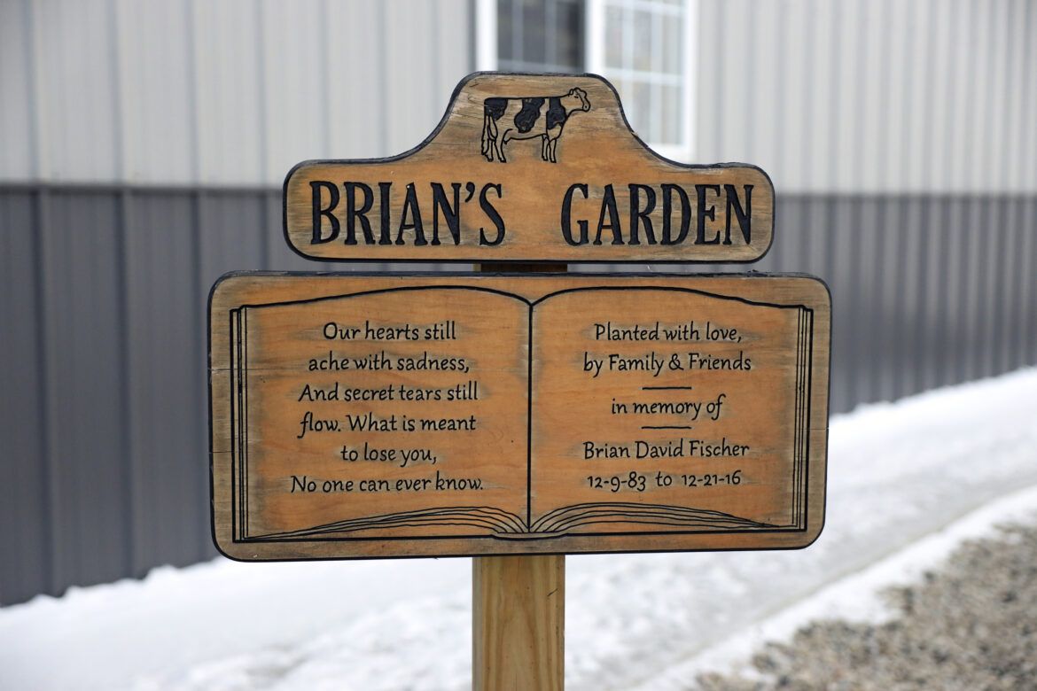 A sign in a memorial garden for Brian Fischer is seen at his parents’ house in Rio, Wis., on Dec. 18, 2020. Fischer died by suicide at the age of 33 on Dec. 21, 2016. Nationwide, farmers face a higher rate of suicide than the national average and above many other professions. Image by Coburn Dukehart / Wisconsin Watch. United States, 2020.