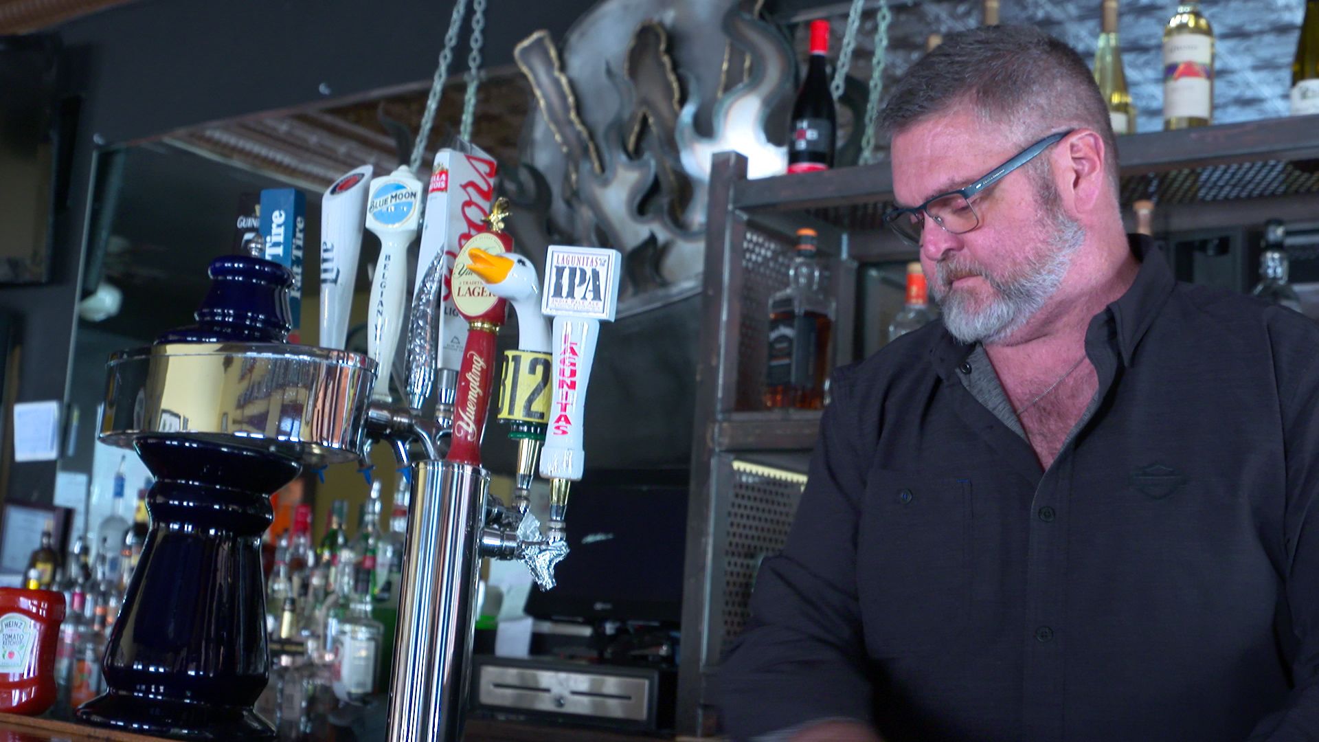 Dave Wagner cleans off the bar at his restaurant Wagner's Ribs in Porter, Indiana. Wagner says he relies heavily on tourist dollars to keep his business going. Image by Alan Mbathi / IPB News.