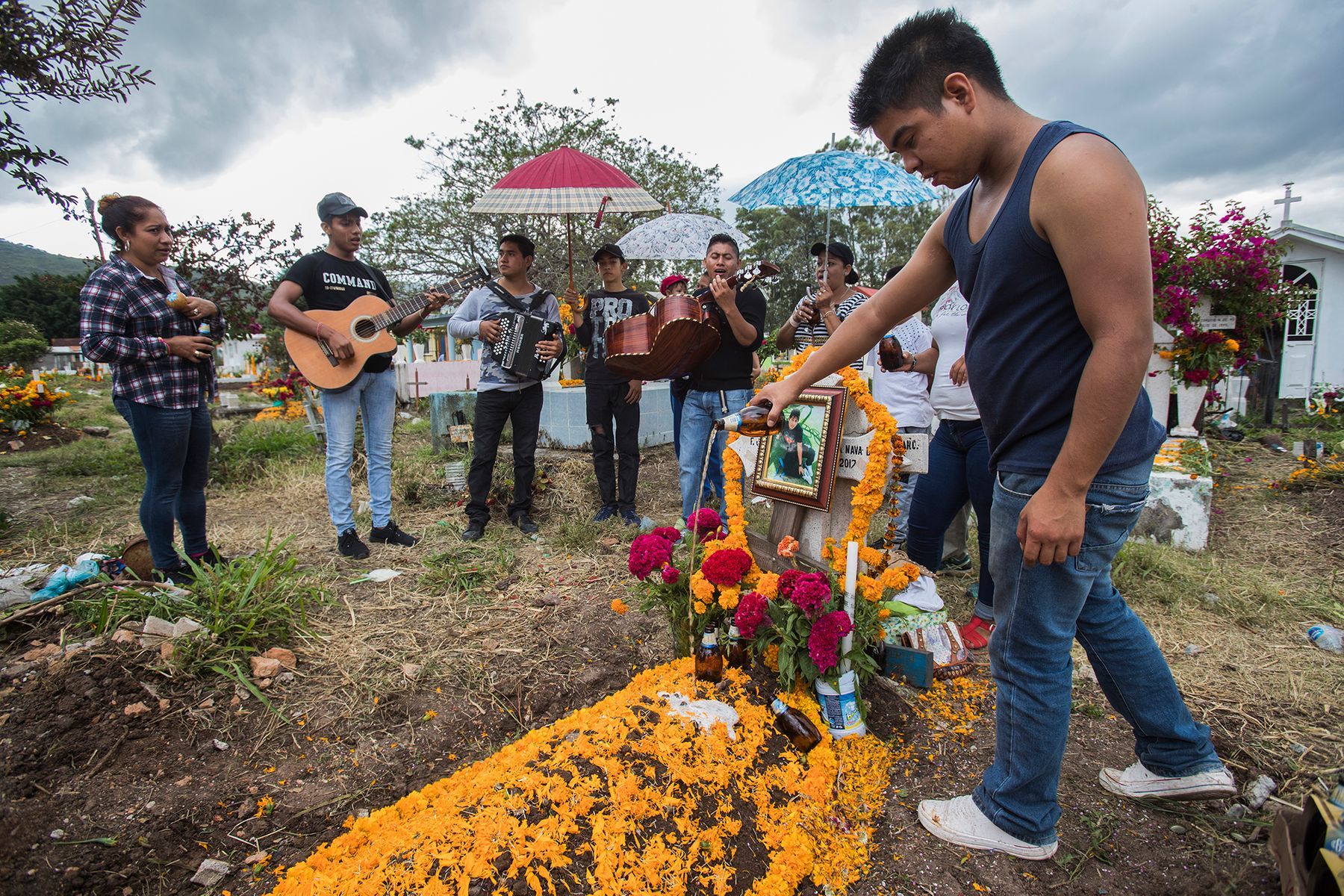 On Day of the Dead, families gather in the Chilapa cemetary to memorialize a young man killed by a cartel. Image by Omar Ornelas/The Desert Sun. Mexico, 2019.
