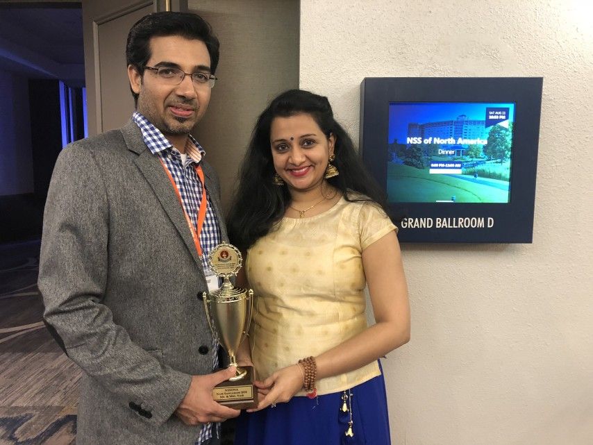 Sujith Kenoth (left) and Swapna Nair, the husband-wife pair who won the title of "Mrs. and Mr. Nair" at the 2018 Nair convention. Image by Kavita Pillay/WGBH News. India, 2018.