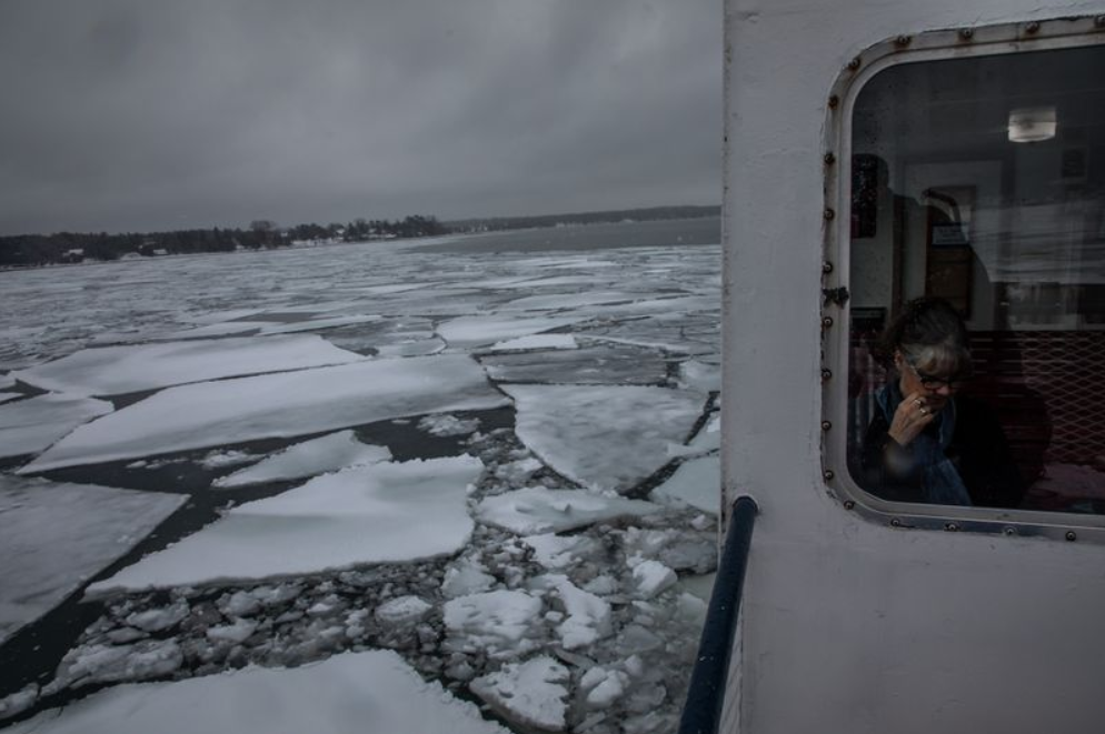 Passenger Marcie Gephart rides on a ferry from Madeline Island to Bayfield, Wisconsin, in January. Image by Zbigniew Bzdak/The Chicago Tribune. United States, 2020.