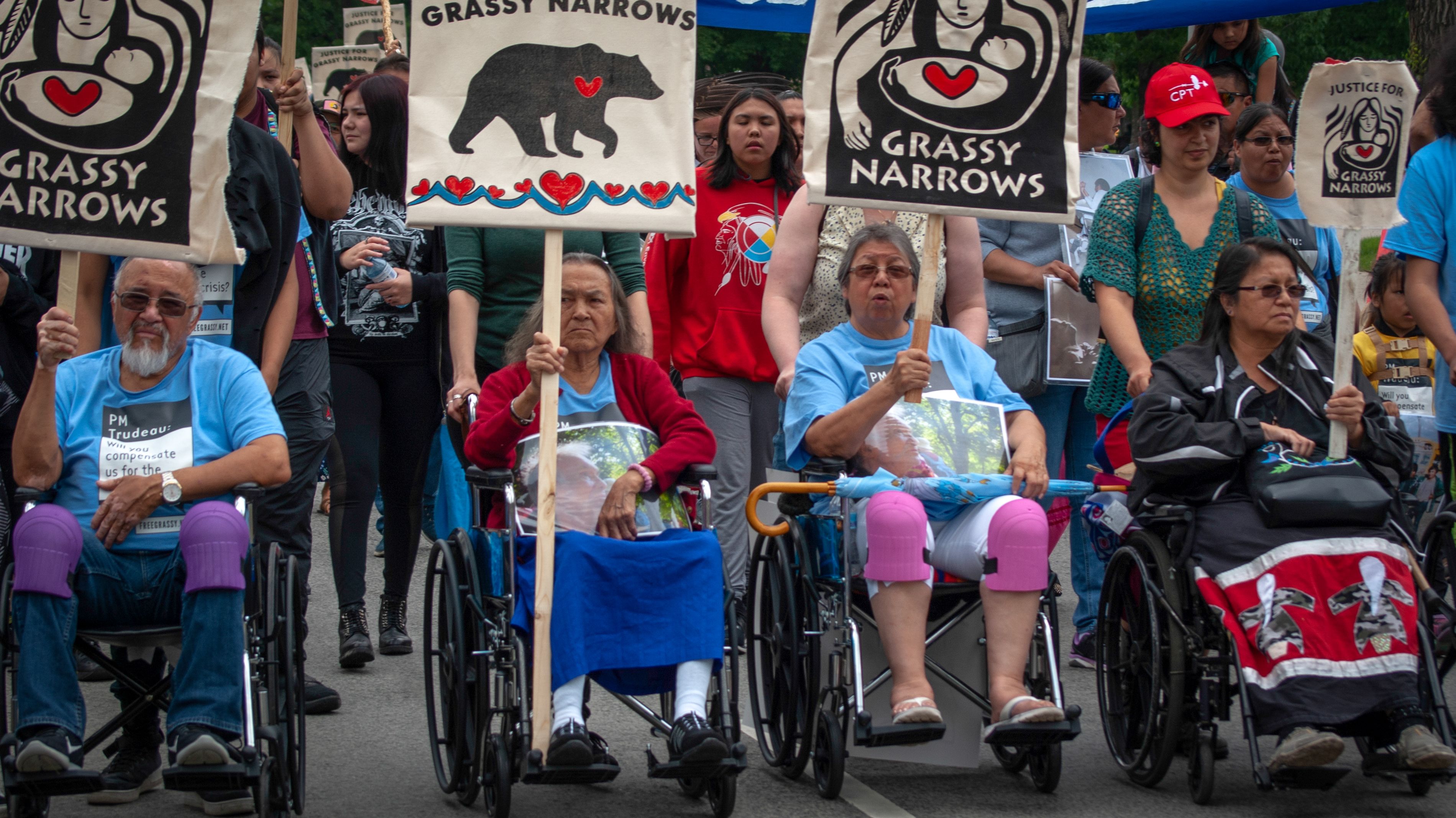 A group of elders including Raphael Fobister (far left) and Judy Da Silva (far right) help to lead the community's march through Toronto. Image by Shelby Gilson. Canada, 2019.