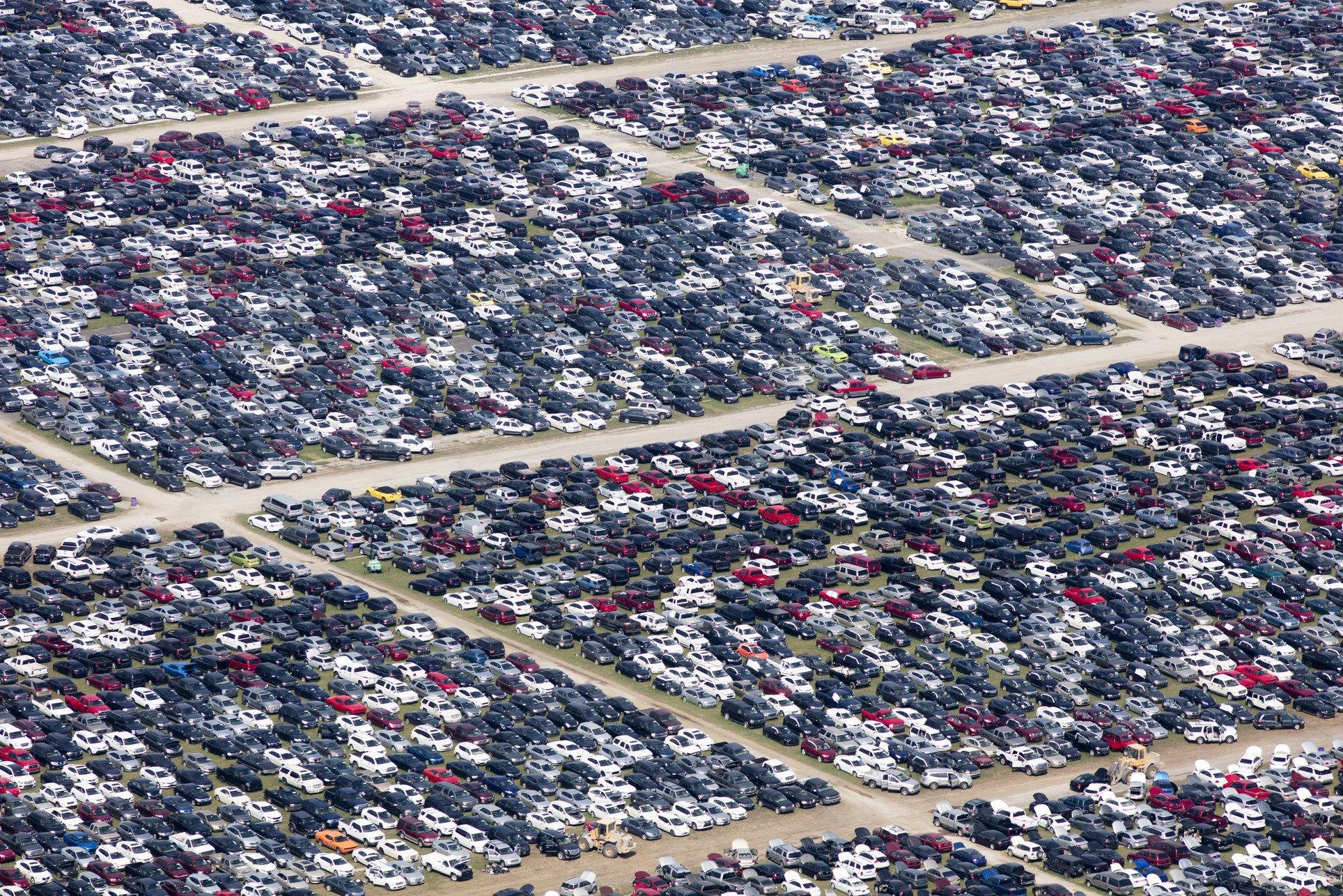 Administrators of the Royal Purple Raceway, in Baytown, Texas, have cancelled its fall schedule and turned the four-hundred-acre property into a temporary lot for about twenty-eight thousand storm-damaged vehicles that await salvage or disposal. Image by Alex MacLean. United States, 2017. 