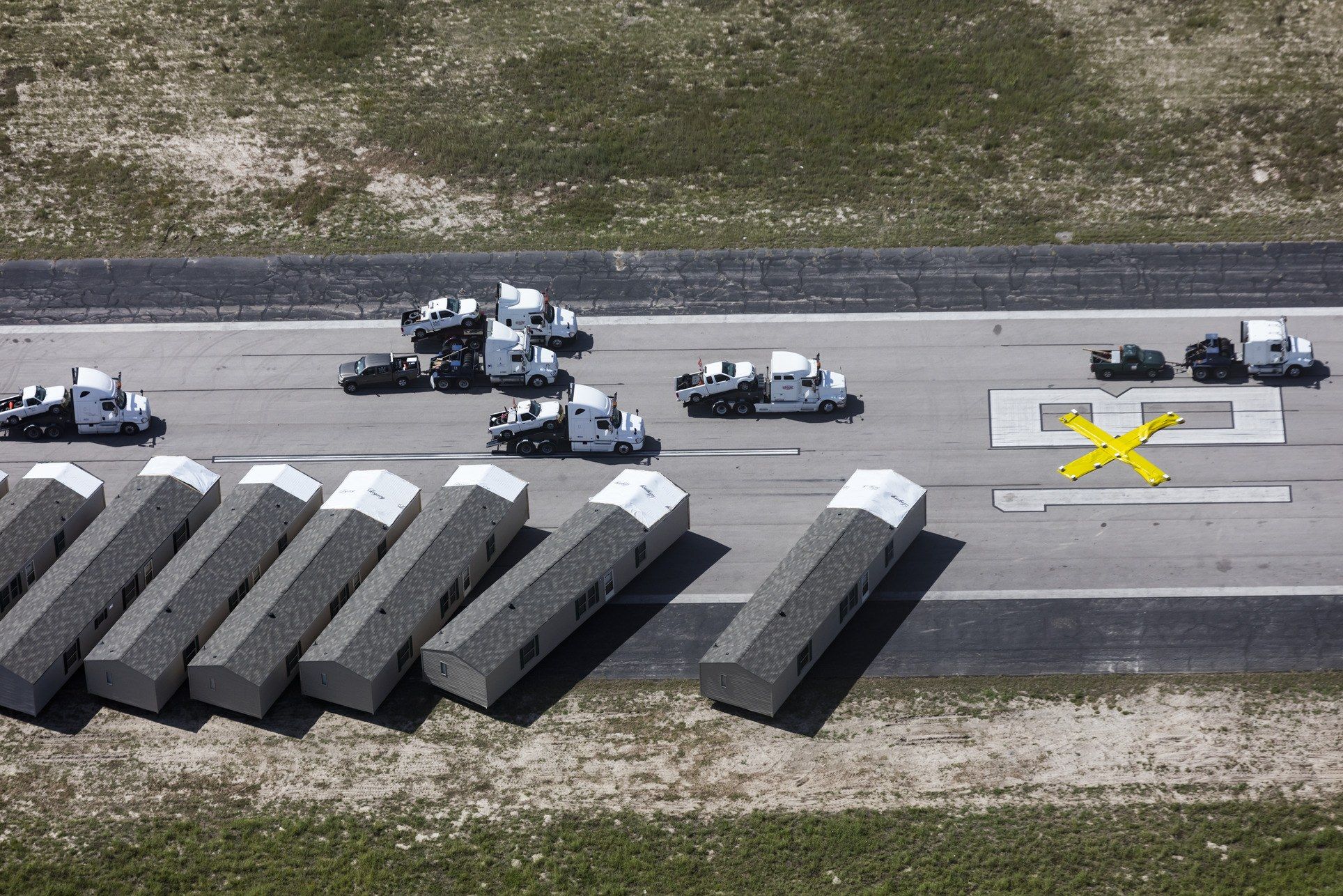 After Hurricane Harvey struck, the north-south runaway at Rockport's Aransas County Airport was converted into a staging area for recovery efforts, first as a lot for utility trucks and then for mobile homes brought in by FEMA to temporarily replace destroyed buildings. Image by Alex MacLean. United States, 2017. 