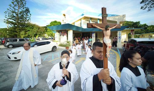Altar servers lead a procession out of the church in Piti in honor of the Assumption of Our Lady. Image by Cory Lum. Guam, 2017.