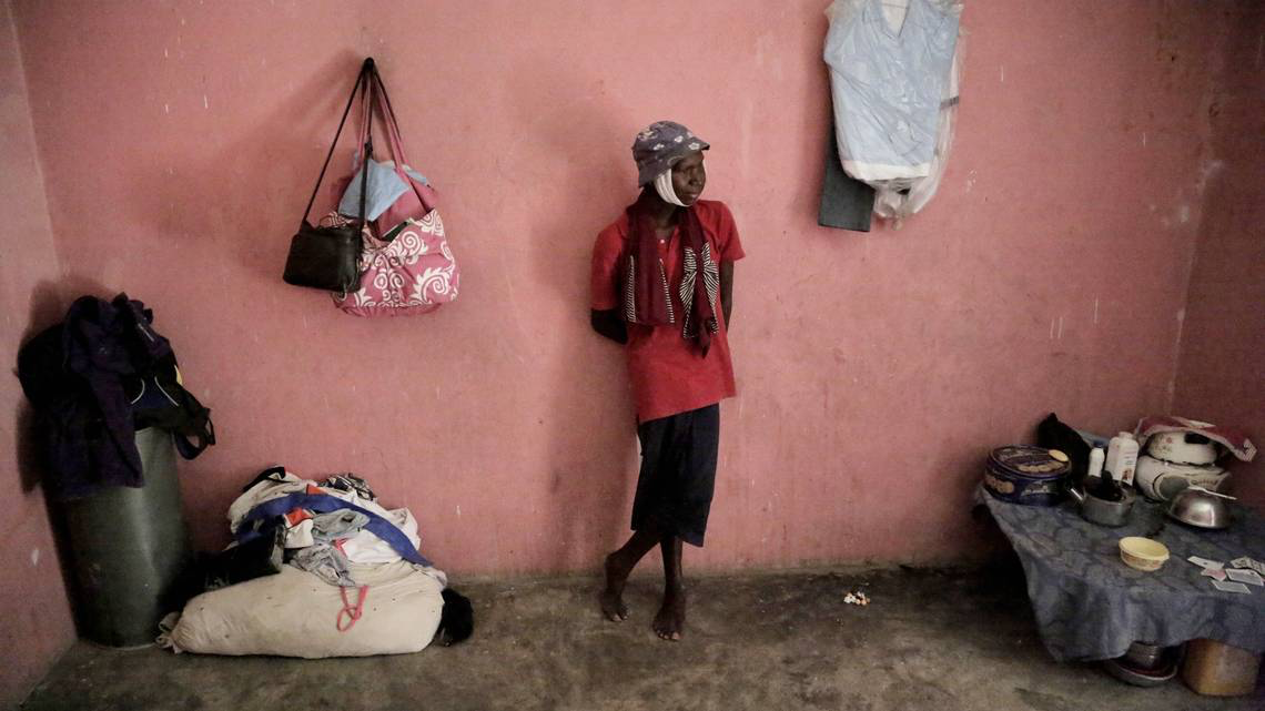 Because of his advanced Burkitt’s lymphoma, Djooly Jeune, 17, was kicked out of school. His 14 year-old sister as well, his mom said because the director feared he was contagious. He’s surrounded by his family’s meager possessions. Image by José A. Iglesias. Haiti, 2018.