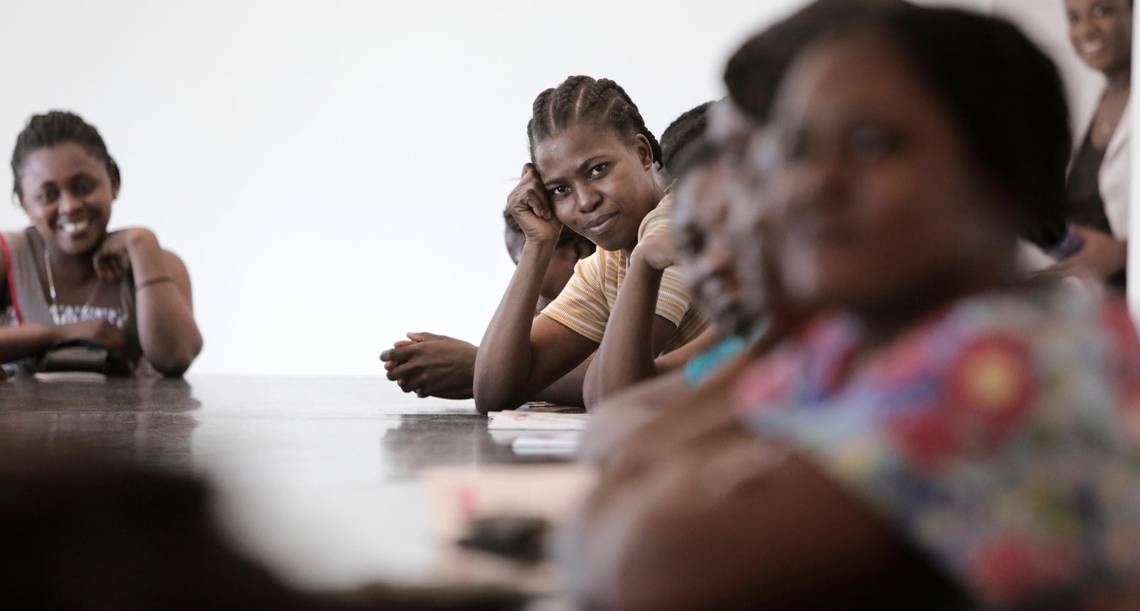 Female factory workers at Cleveland Manufacturing in Port-au-Prince listen to midwife Nanotte Louis as she urges them to get screened for cervical cancer. Louis’ employer, Innovating Health International, launched the factory “see-and-treat” program in October 2017 along with Share Hope Haiti. Image by Jose A. Iglesias. Haiti, 2018.