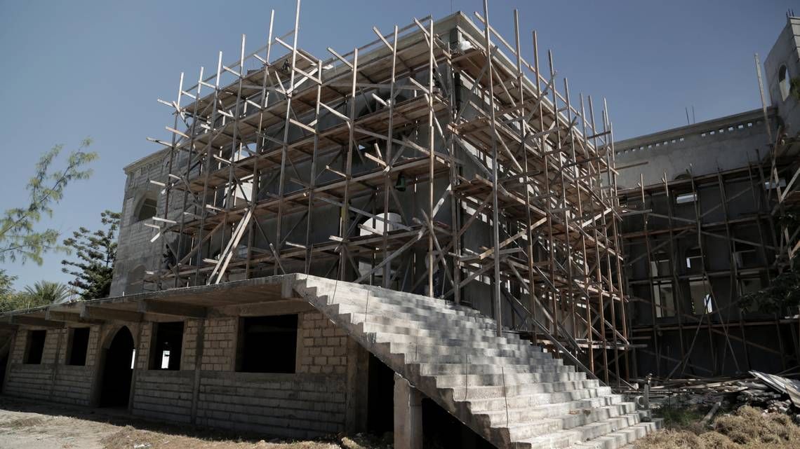Scaffolding lines the outside wall of Notre-Dame du Perpétuel Secours in Delmas’ Fragneauville neighborhood. The parish priest said everything including the massive concrete dome has been built to earthquake code. Image by Jose A. Iglesias. Haiti, 2020.