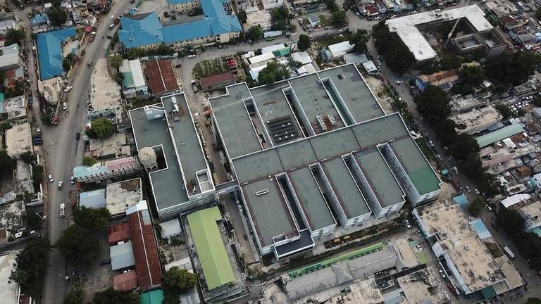 Aerial view of the new State University of Haiti Hospital in Port-au-Prince. The sprawling new hospital campus was one of the first projects approved for Haiti’s reconstruction after the Jan., 12, 2010 earthquake. A decade later, the 534-bed teaching hospital has yet to open its doors to a single patient. Image by Jean Marc Hervé Abélard / The Miami Herald. Haiti, 2019.