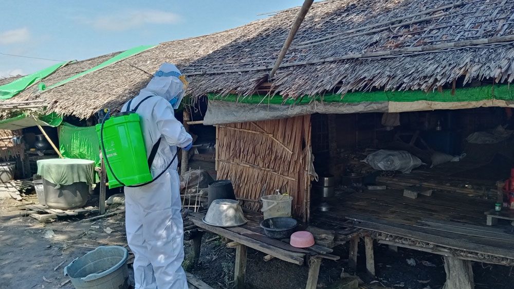 A volunteer sprays disinfectant in Tain Nyo, a camp for internally displaced persons, in Mrauk-U township in Rakhine State earlier this month. Myanmar, 2020.