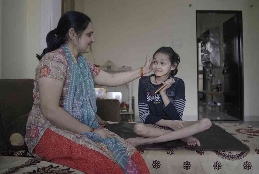 Ayushi, 12, with her mother Jyoti. Image by Rohit Jain. India, 2020.