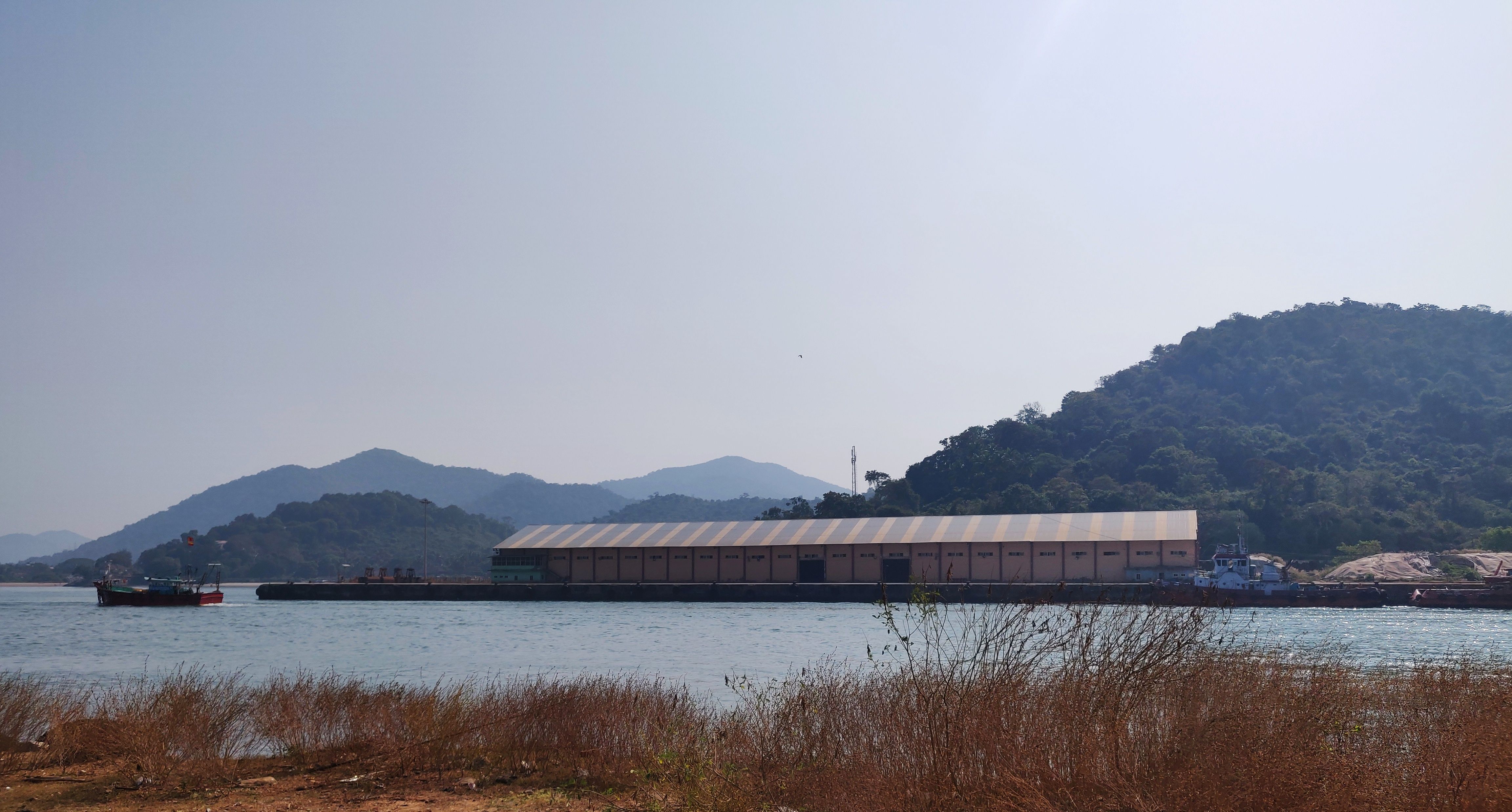 The Karwar port (pictured above) is at the southern end of the narrow beach. Apart from a new cargo terminal, new structures such as breakwaters on the beach and the expansion of roads leading to the port, are proposed to be built. These could severely disturb fishing activity in the area. Image by Disha Shetty / IndiaSpend. India, 2020.
