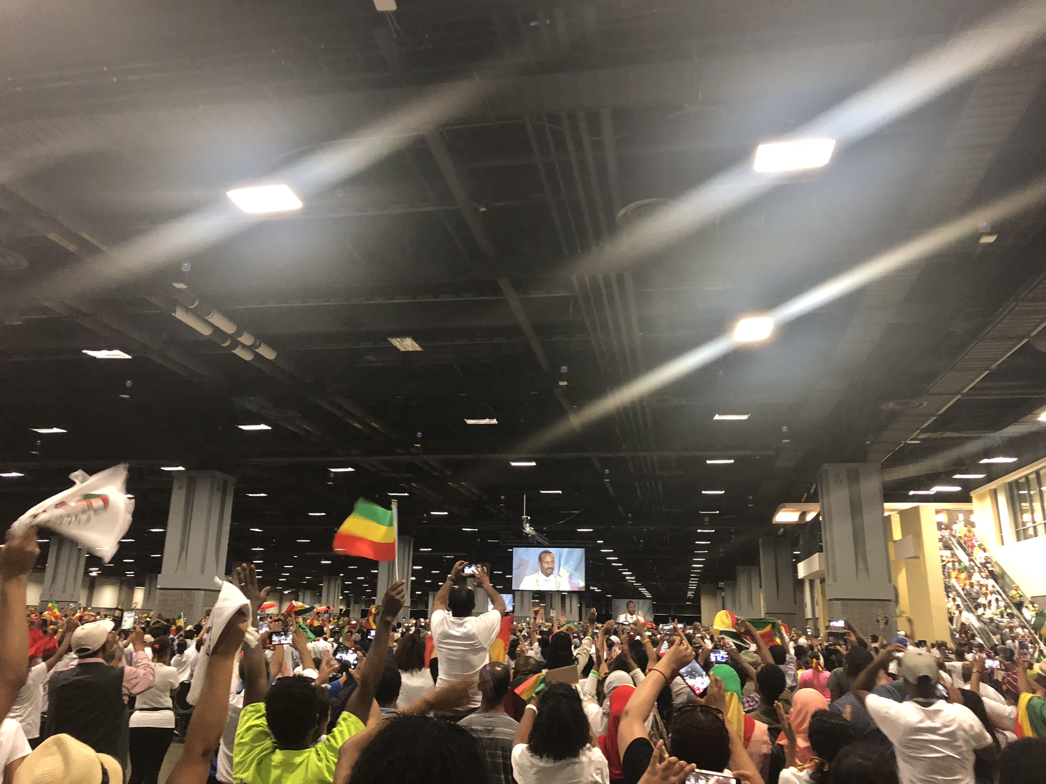 That afternoon, a lucky fraction of the crowd who had been waiting since the early hours of the morning would make it into the room where Abiy would give his speech. Others were packed into rooms with large TVs to watch his speech live. Image by Claire Potter. Unites States, 2018. 