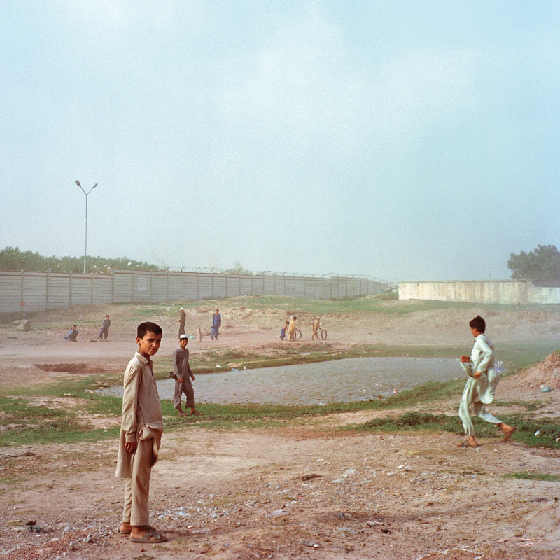 Children play near a pond. Image by Sara Hylton. Pakistan, 2018.