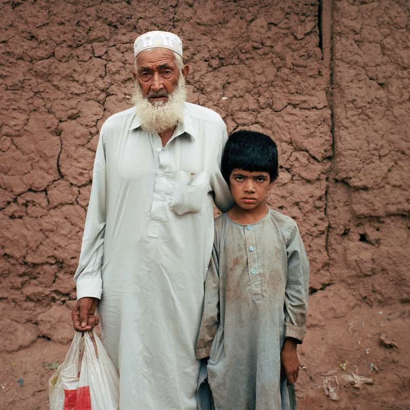An elder poses for a portrait with his son. Image by Sara Hylton. Pakistan, 2018.